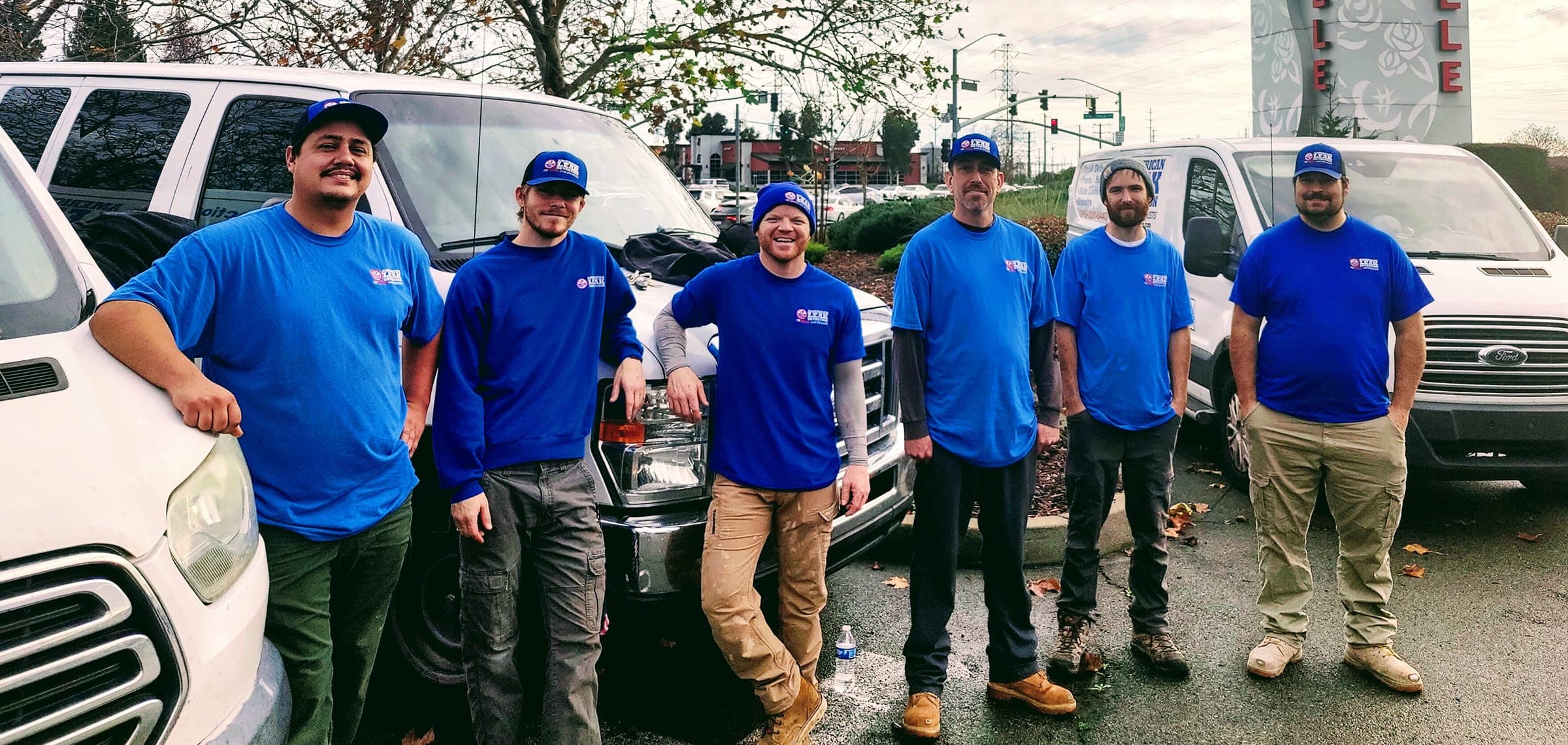 American Leak Detection of Sacramento technicians standing beside service vans.