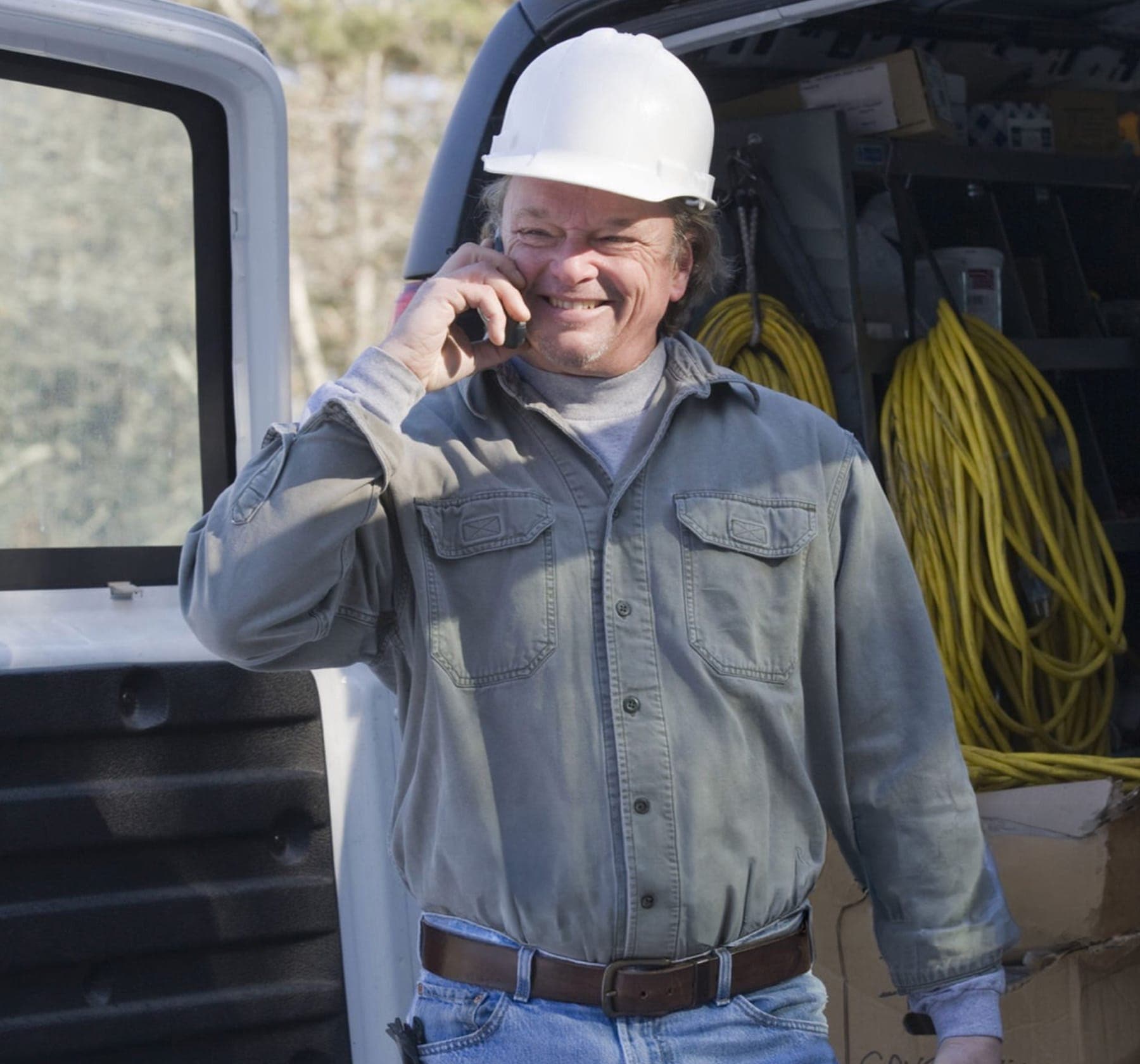 Technician taking a field call beside a service vehicle in Nevada County.