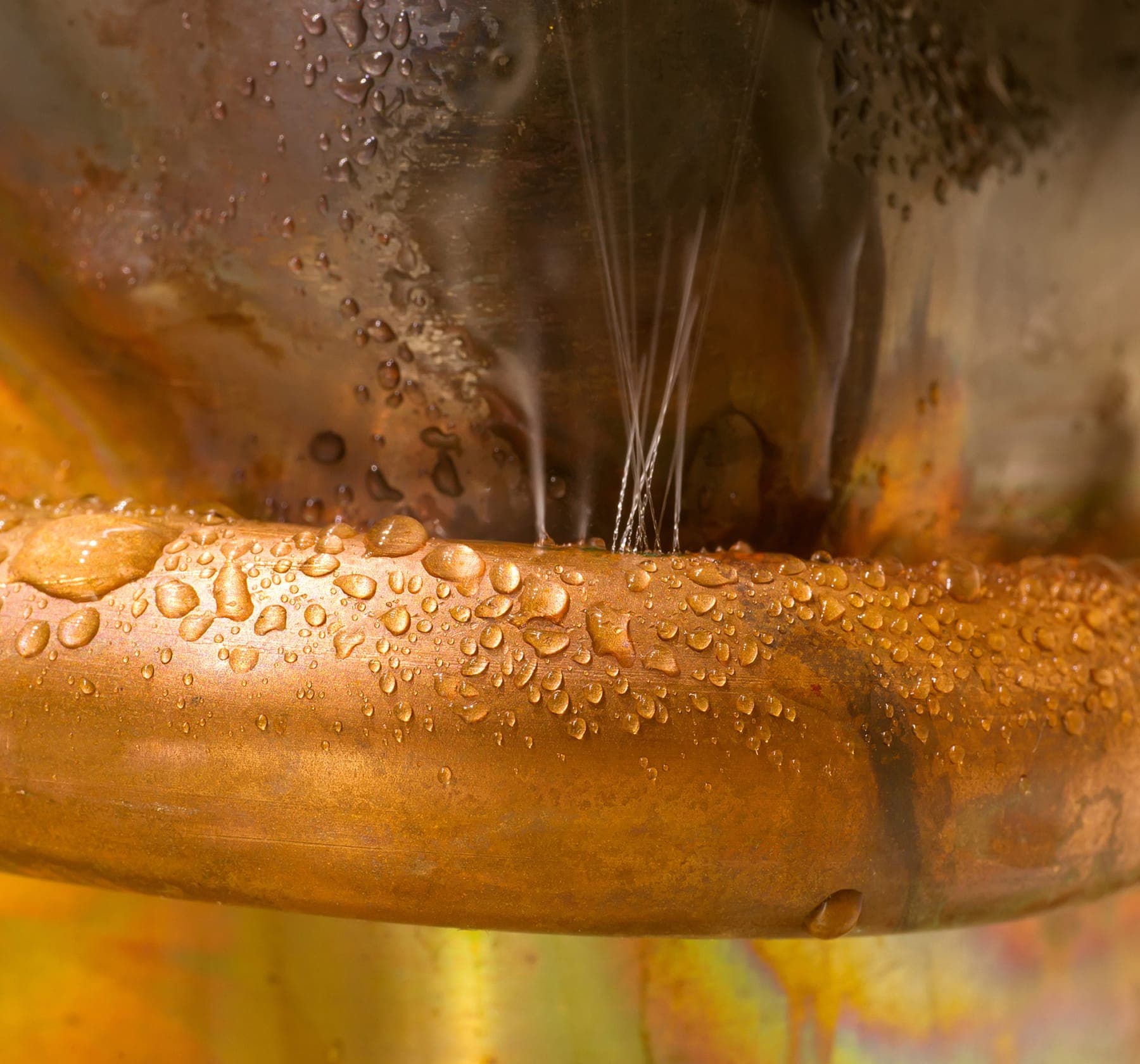 Pinhole leak spraying water from a copper pipe during a Placer County diagnostic visit.