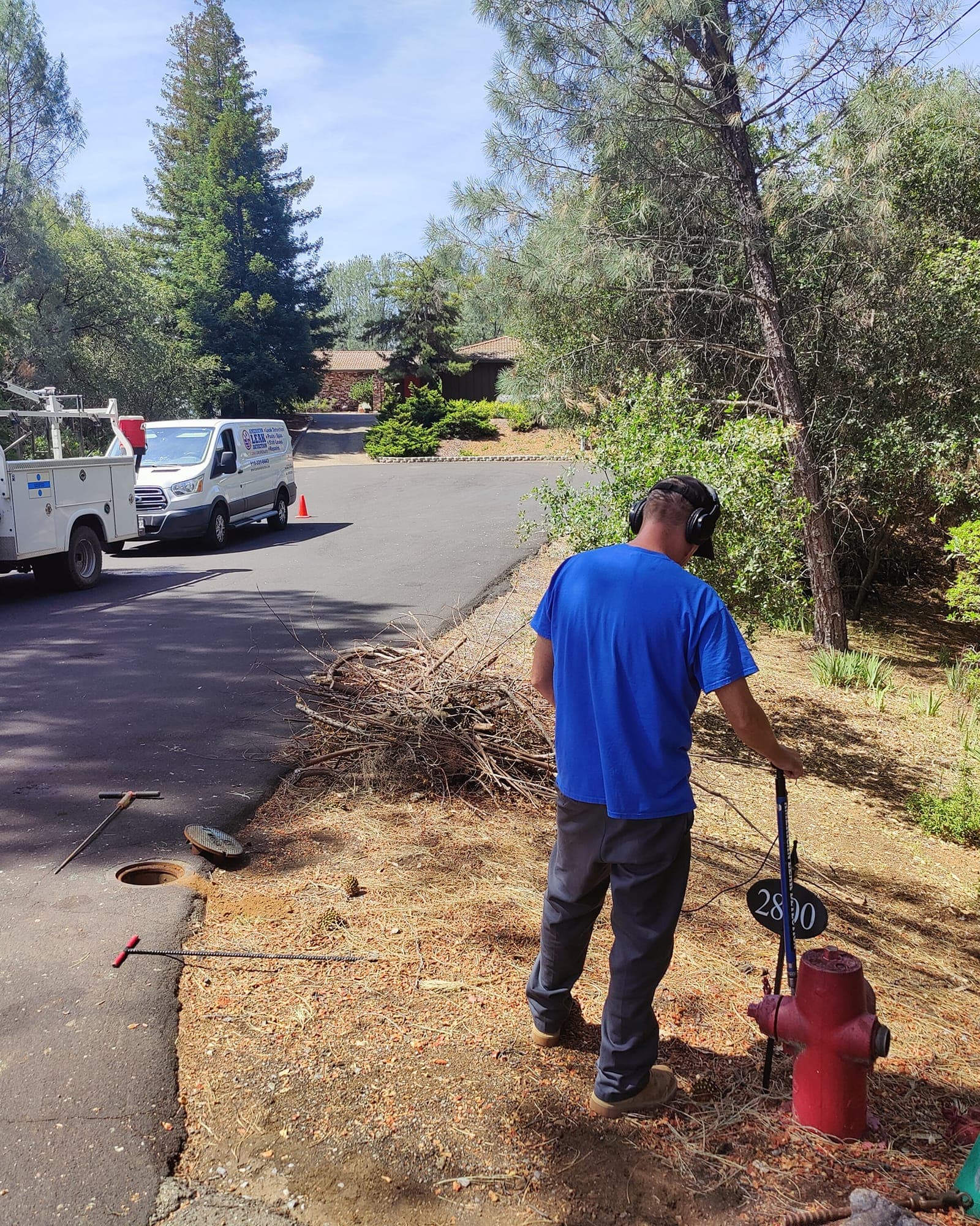 Technician locating an underground leak along a Sacramento County residential street.