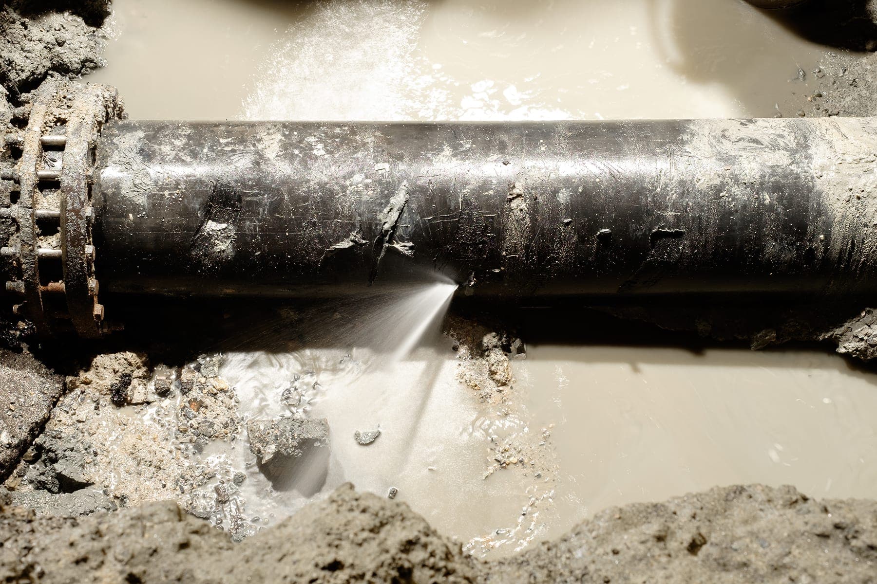 Water leaking from a commercial pipe during a diagnostic inspection.