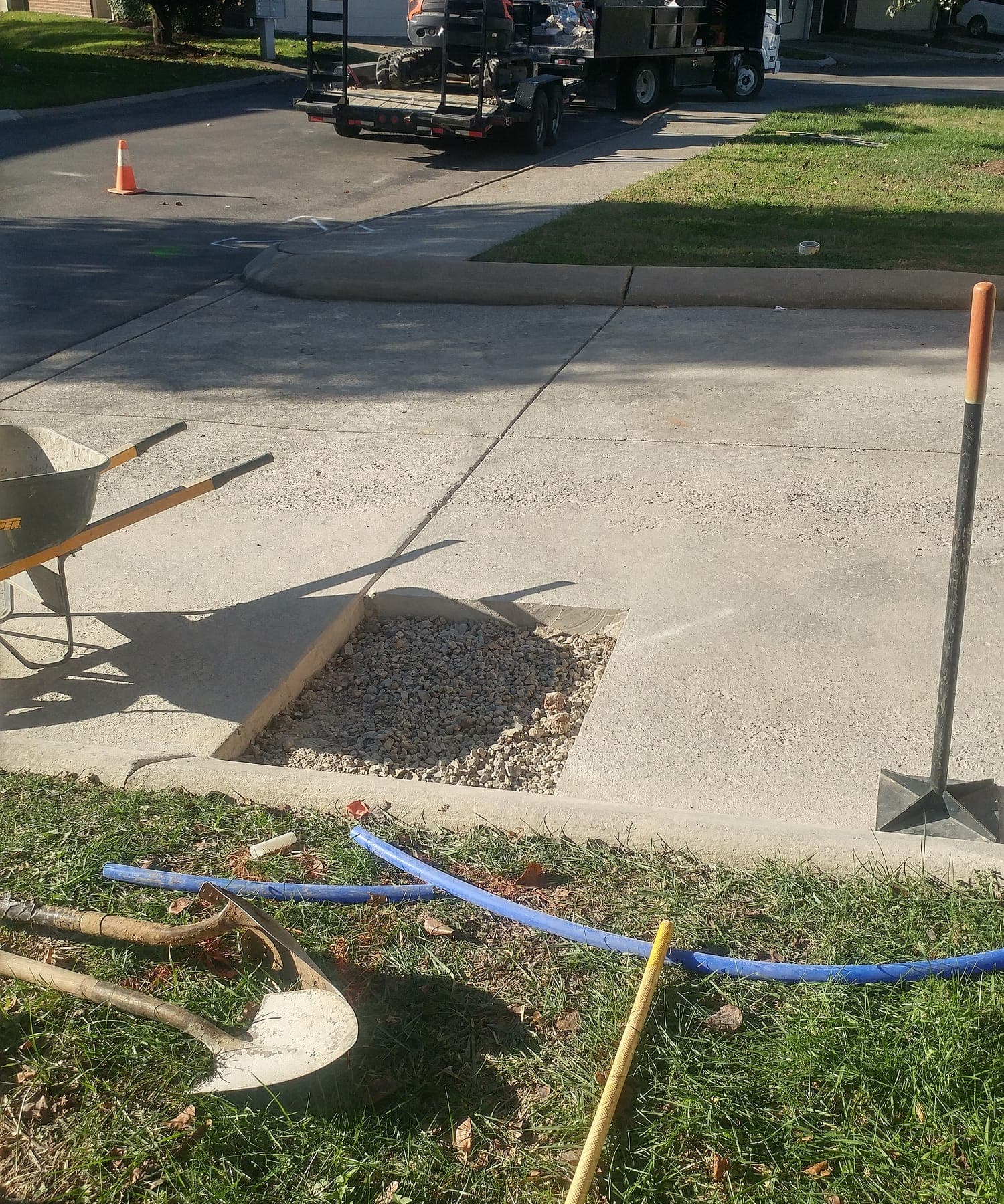 Water pooling near a driveway as a possible slab or underground leak symptom.